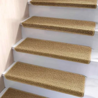 Light brown textured sisal stair treads with rounded corners on white stairs.