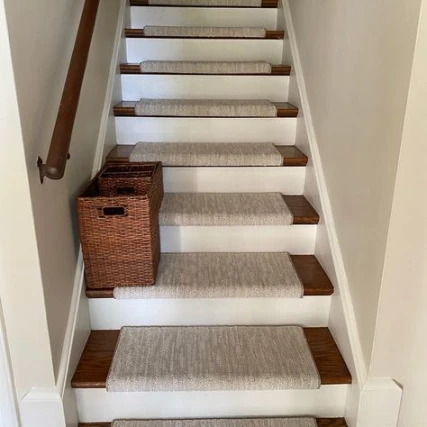 Sisal-style light brown stair treads on dark wood stairs with white risers.