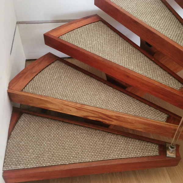 light brown sisal carpet inlay framed by rich, reddish-brown wood.