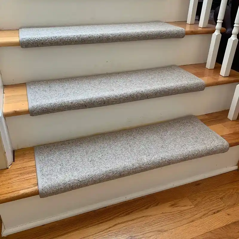 “Non-slip carpet stair treads installed on wooden stairs.”