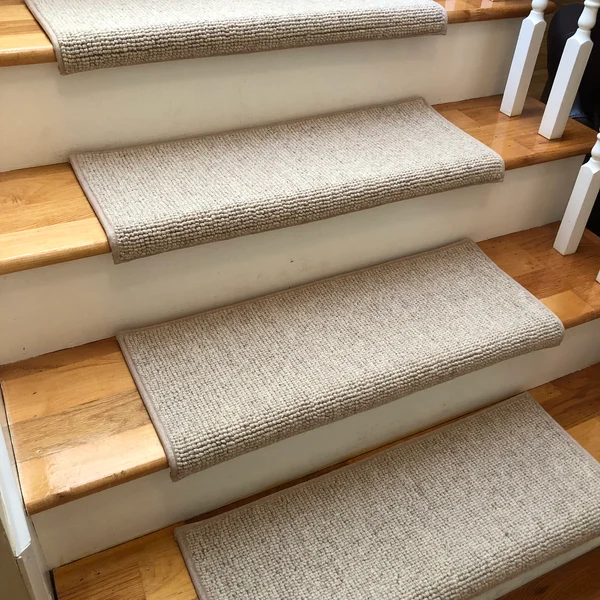 Plush grey carpet stair treads with a matching landing rug.