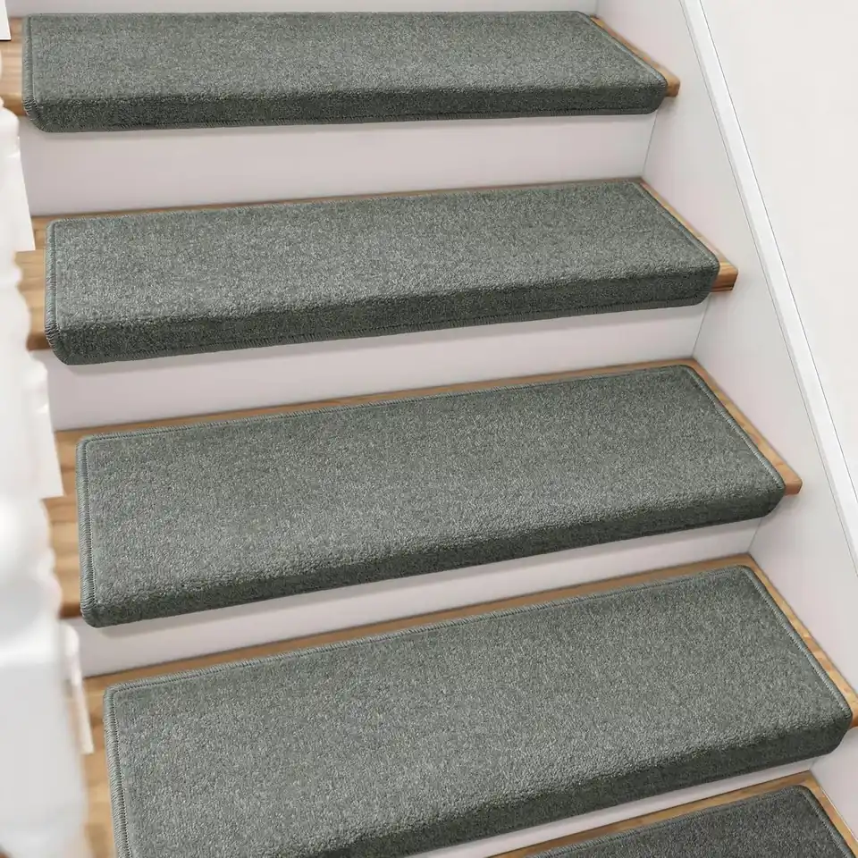 Beige textured carpet treads on dark wood stairs
